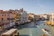 View on Grand Canal with vaporetto and gondolas in Venice. Venetian water transportation concept. Idea of traveling Italy. Cityscape in autumn sunny day