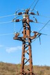 Old rusty electricity supply. High voltage power line. Electricity pole and wires on a sky background. Rusty iron electric pole with electric wires