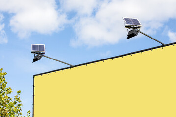 Yellow advertising banner. Led lighting and solar panels