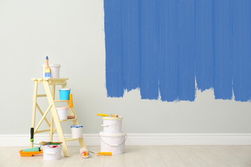 Canvas Print - Decorator's kit of tools and paints near wall indoors