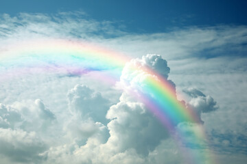 Wall Mural - Beautiful view of bright rainbow in blue sky on sunny day