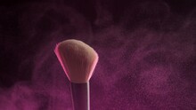 Makeup Brushes Touch Each Other On Dark Background And Small Particles Of