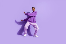 Full Length Photo Of Sweet Millennial Guy Dance Wear Hoodie Pants Sneakers Isolated On Violet Color Background