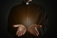 Priest Reaching Out His Hands With Holy Light On Dark Background, Closeup