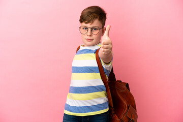 Little redhead caucasian boy isolated on pink background with thumbs up because something good has happened