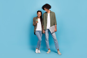 Poster - Photo of two friends partners hold netbook use smart device search network news wear jeans isolated blue color background