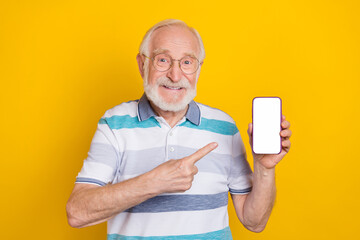 Sticker - Portrait of attractive cheerful grey haired man showing display copy space app isolated over bright yellow color background