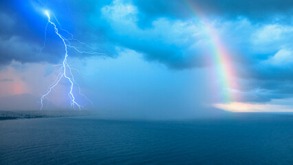 Fototapete - Storm over the sea with lightning and rainbow