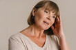 © Drobot Dean - White mature woman wearing t-shirt posing and looking aside