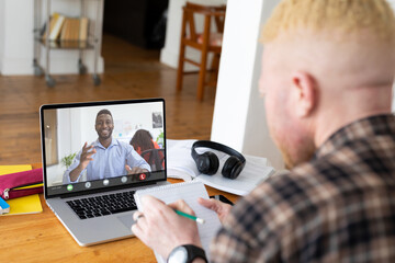 Sticker - Multiracial businessmen planning strategies while video conferencing through laptop in office