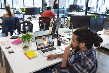 Poster - African american businessman and businesswoman having meeting through laptop in office