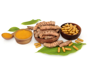 Healthy turmeric root spice with leaves, powder, dietary supplement capsules. Used in food seasoning and natural herbal medicine. Is anti inflammatory, an antioxidant and has many health benefits.  