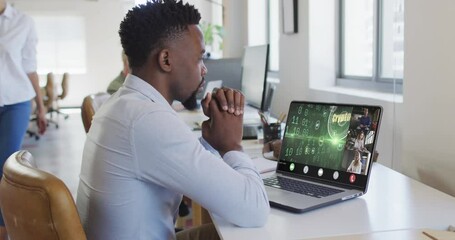 Wall Mural - African american businessman using laptop for video call with diverse business colleagues