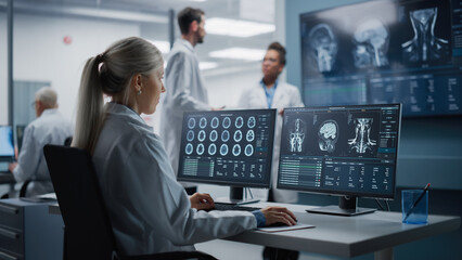 Medical Hospital Health Care Lab: Portrait of Female Medical Scientist Using Computer with Brain Scan MRI Images, Finding Cure. Professional Neurologist Analysing CT Scan Finding Cure for Sick Patient