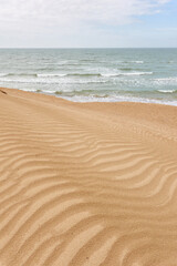 Wall Mural - Panoramic view of the Baltic sea shore on a sunny spring day. Beach, sand dunes. Soft sunlight. Idyllic seascape. Nature, environment, vacations, eco tourism, exploring concepts