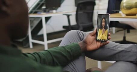 Sticker - Video of african american man having video call on smartphone with biracial female coworker