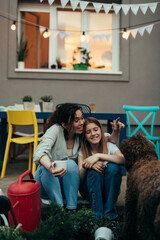 Wall Mural - mother and daughter sitting and enjoying in backyard