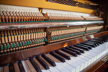 Open upright piano. Piano action close up. Piano action, internal mechanism. Piano tuning, repair restoration or maintenance. Piano hammers.