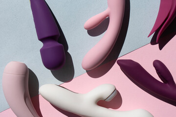 Wall Mural - Collection of different types of sex toys on a blue and pink background. Sex toys for adults, dildos, vibrators, clitoral stimulators.