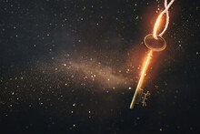 Golden Key With Glowing Lights And Dark Background, Wisdom, Wealth, And Spiritual Concept