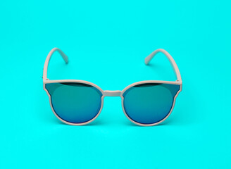 Wall Mural - Fashionable sunglasses on a bright turquoise background