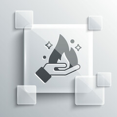 Sticker - Grey Hand holding a fire icon isolated on grey background. Square glass panels. Vector