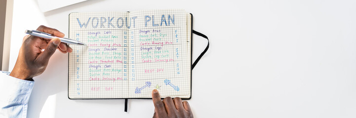 Wall Mural - Person Making Note Of Workout Plan On Notebook