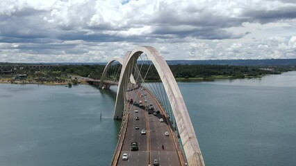 Wall Mural - Aerial view of traffic on JK Bridge (Portuguese: Ponte JK ), a steel and concrete arch bridge across Lake Paranoa in Brasilia, Federal District, capital of Brazil.