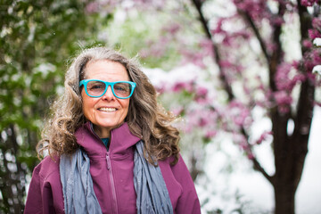 Wall Mural - A portrait of a woman wearing a fun pair of glasses outside in nature on a beautiful day in Colorado, USA