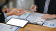© Prathankarnpap - Cropped shot business colleagues discussing project strategy while having conversation on financial data report together