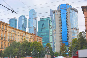 old soviet buildings and modern skyscrapers in different colors