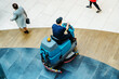 © Dmitry - floor washcloth. Washing floors in a shopping center. Cleaning in a large industrial area using automated equipment. Top down view