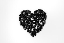 Black Vitamins, Pills In The Shape Of A Heart On A White Background. For Pharmacies, Backgrounds, Medicine, Vitamins, Healthcare Workers
