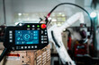 © InfiniteFlow - Robotic arm and its controller adept panel in a factory workshop . Industry robot programming software for automated manufacturing .