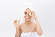 Beautiful Woman Holding Slices Of Cucumber In Front Of Her Eyes