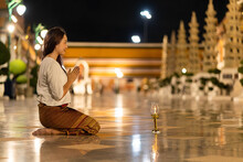 Portrait Asian Woman To Paying Respect To Buddha Statue At Wat Suthat Thepwararam