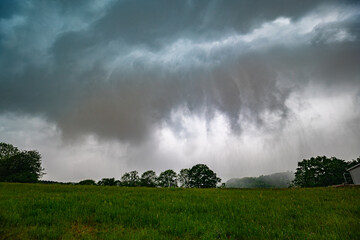 Poster - Ominous sky approaching when the cold rain of a thunderstorm passes over the land like a steam roller