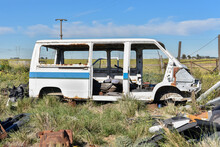 Abandoned School Bus. Old Damaged Cars In The Junkyard. Car Graveyard.