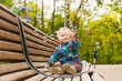 © Minakryn Ruslan  - portrait of a little boy in the park on a bench catching soap bubbles
