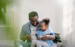 canvas print picture Portrait of american african black father and be loved daughter hug bonding in living room. Happy daddy his little girl spending leisure time at home. Single dad, family lifestyle father's day concept