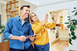 © baranq - Middle aged couple at home planning living room design