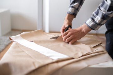 professional tailor cut textile with scissors in the shop