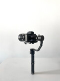 Fototapeta Zwierzęta - modern camera equipment, black stabilizer tripod with video cinema camera