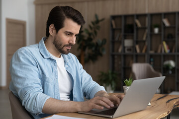 Wall Mural - doing business. focused millennial businessman expert freelancer type on laptop keyboard prepare sal