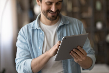 Wall Mural - digital tablet. close up of casual guy student employee use electronic pad pc make call purchase onl