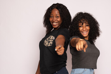 excited black girls excitedly pointing towards the viewer