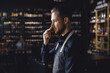 © Parilov - Sommelier man in apron listens to aroma of red wine, sniffs cork, black background