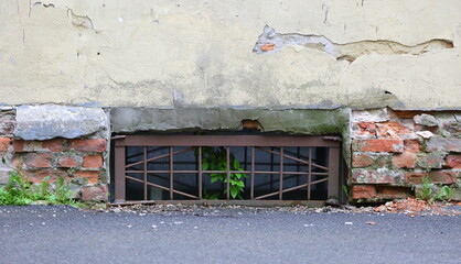 Wall Mural - A basement window with a metal barrier