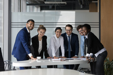 Canvas Print - Company professional successful staff members portrait concept. Six multi ethnic young, ambitious employees gather in boardroom, working together take part in seminar meeting smile staring at camera