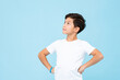 © Atstock Productions - Handsome mixed race boy thinking and looking up with arms akimbo in isolated studio light blue color background
